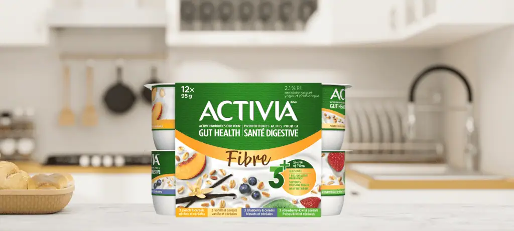 Activia source of fibre yogurt on kitchen counter