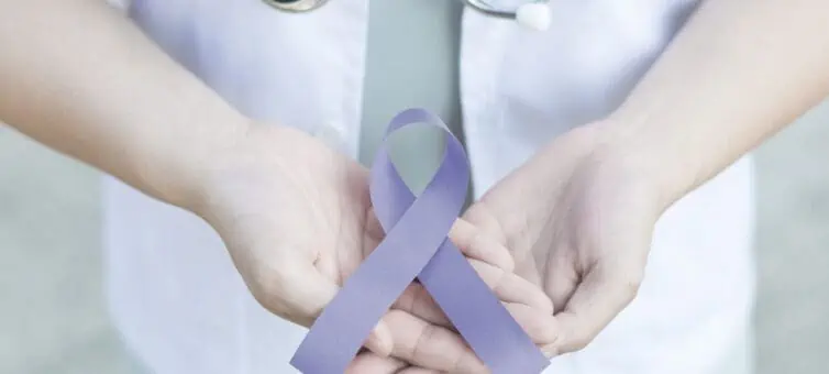man holding a lilac ribbon for esophageal cancer