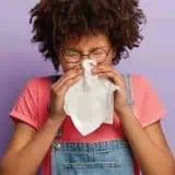 Women blowing her nose