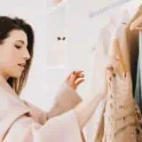 Women looking at her clothes in her closet