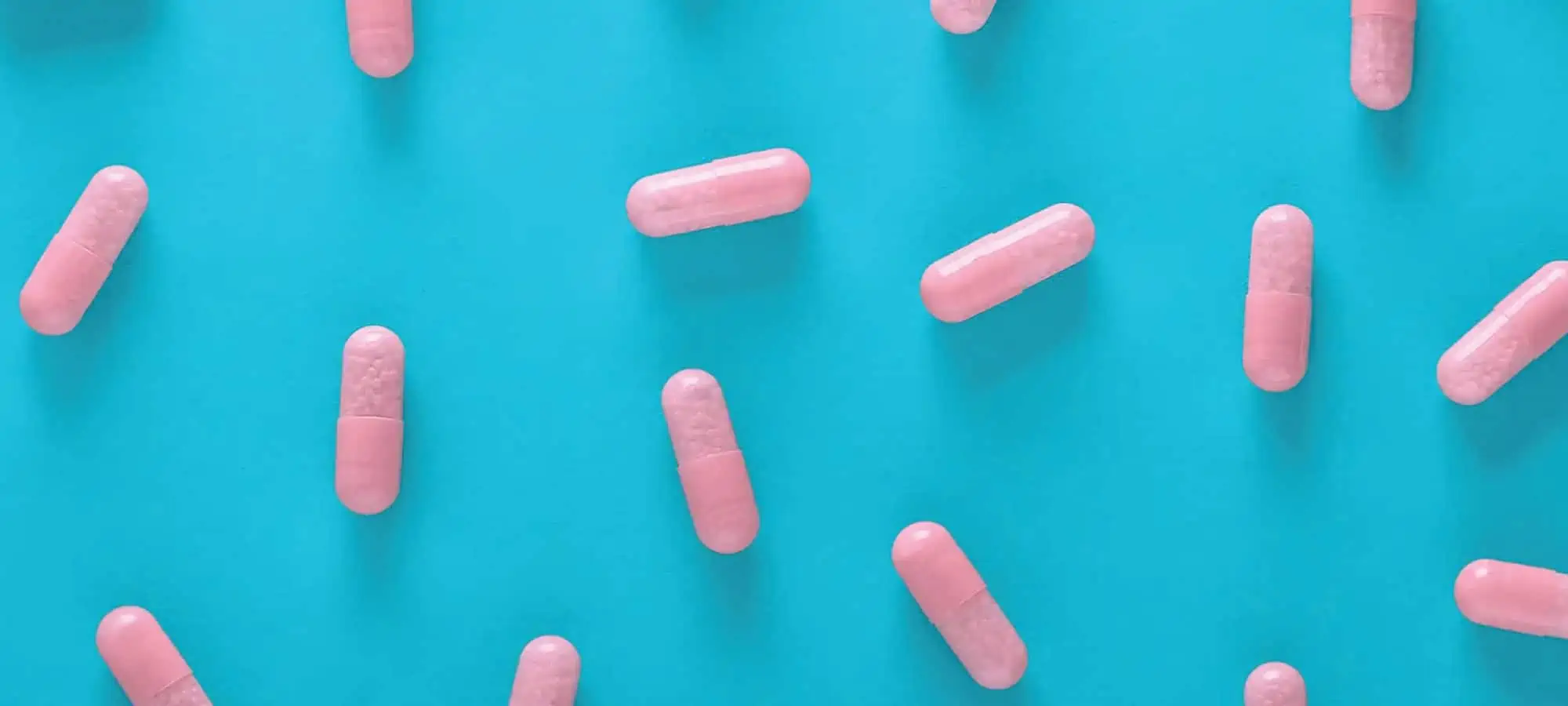 Pink pills on a blue background