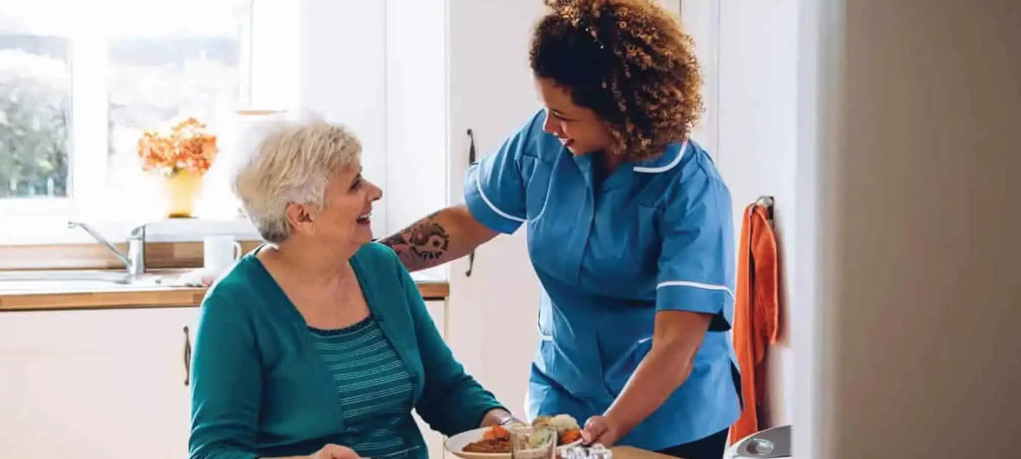 Senior and nurse speaking 