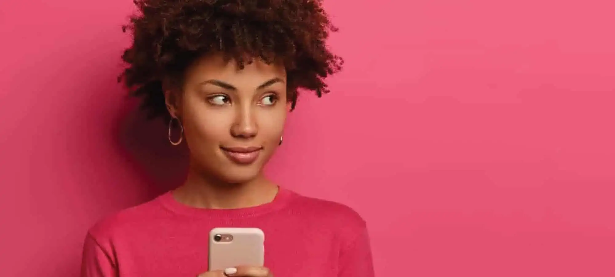 Women looking off to the side with her cell phone in hand