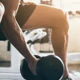 Man lifting a weight in the gym