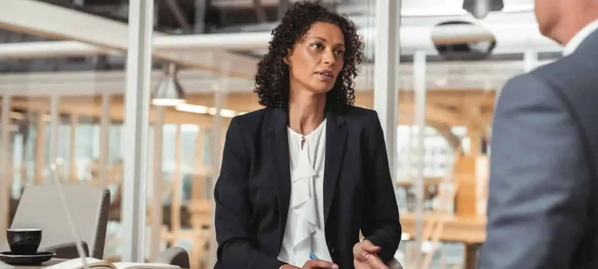 Women speaking to collegue in an office
