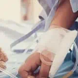 Bear on hospital bed with child