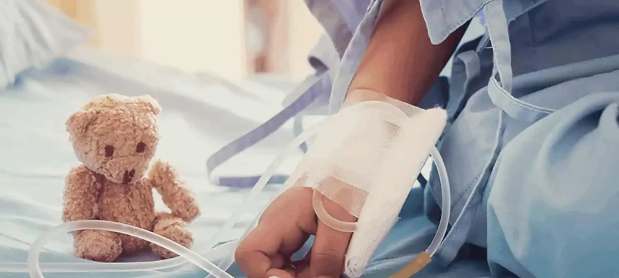 Bear on hospital bed with child