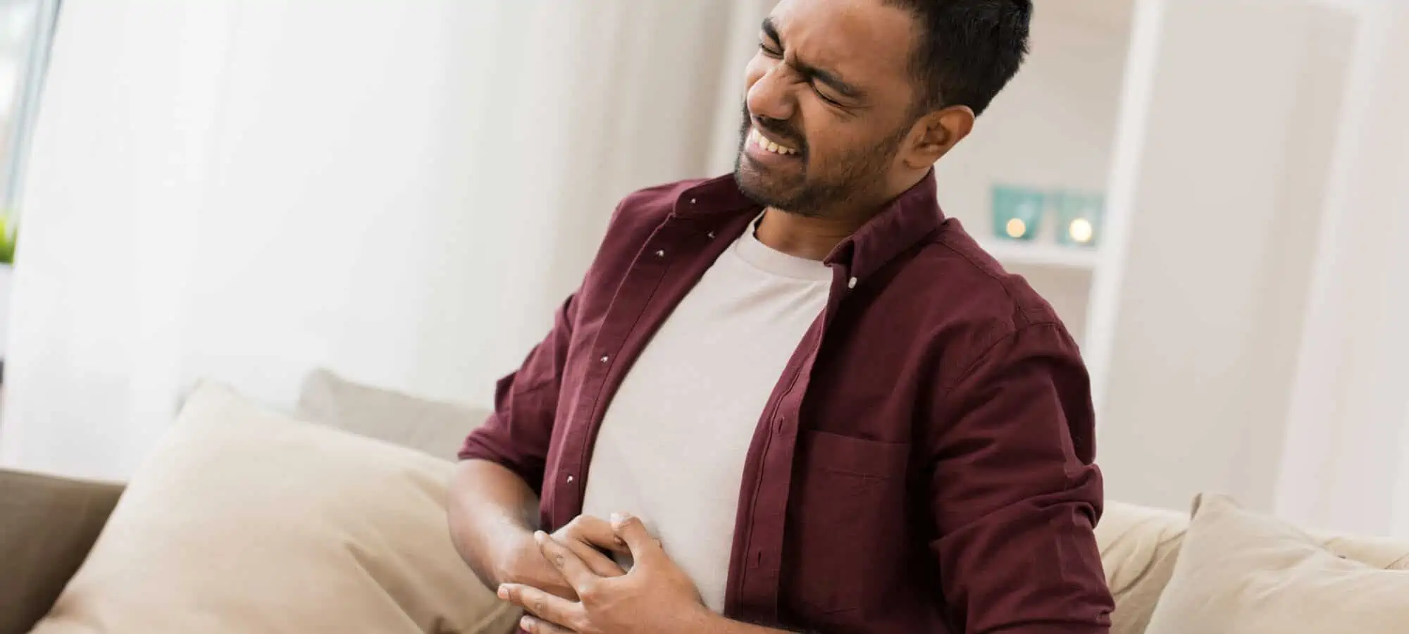 South Asian man in pain from stomach