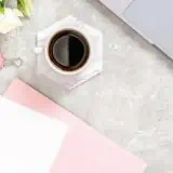 Writing in notebook at a desk