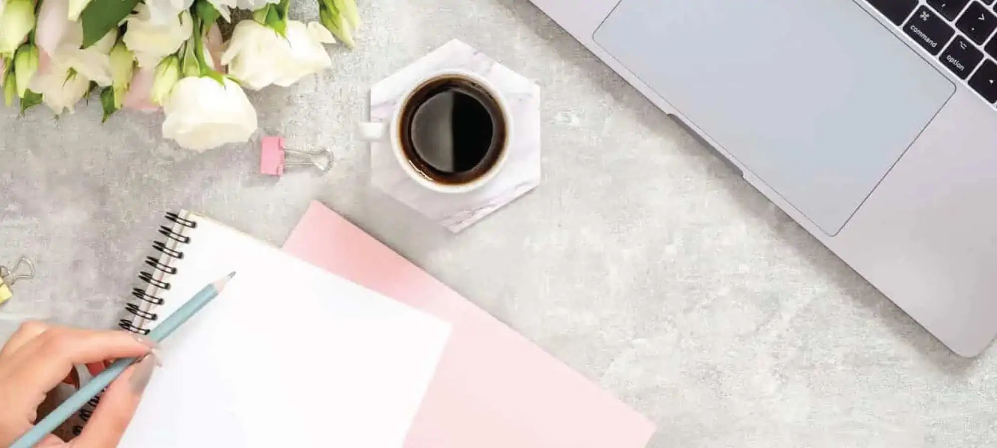Writing in notebook at a desk