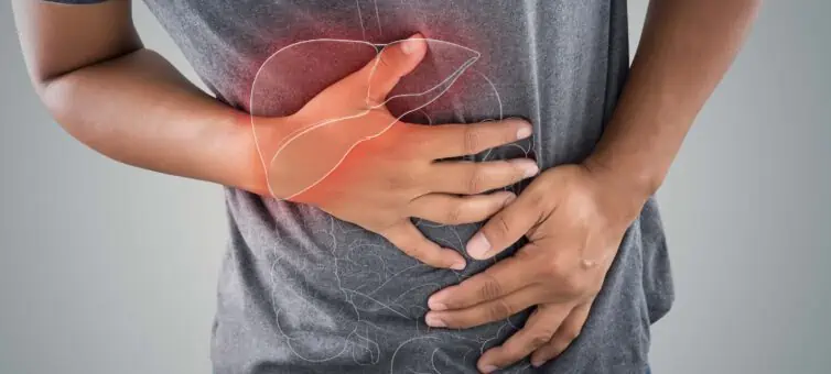 man clutching his stomach with an overlay of the pancreas