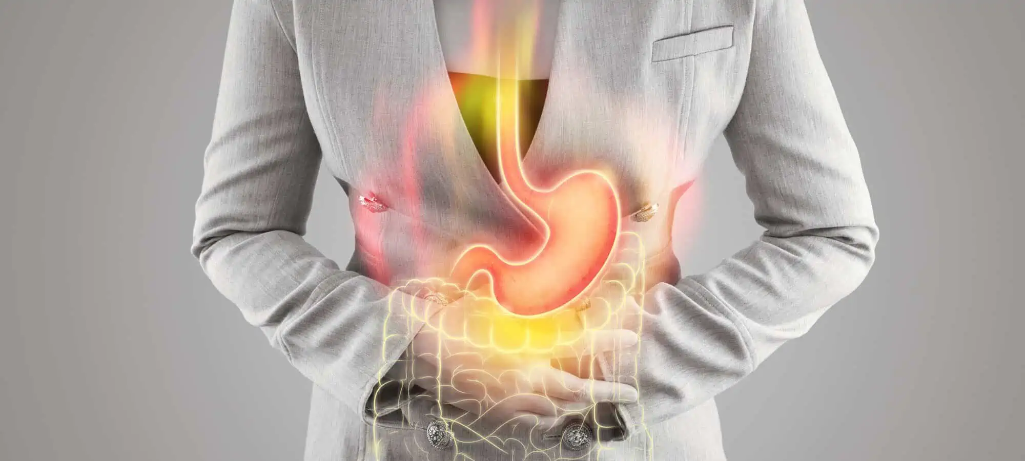 Woman in black and white clutching her stomach with an overlay of the stomach