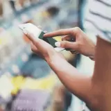 woman checking for gluten-free ingredients on phone