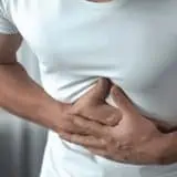 Man clenching stomach