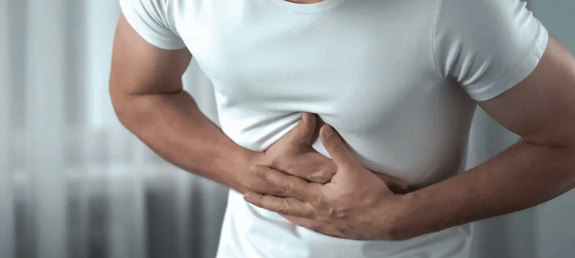 Man clenching stomach