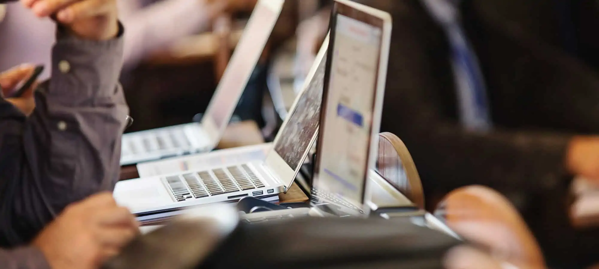 People sitting on a computer listening to a presentation