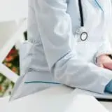 Registered dietitian writing in notebook on desk