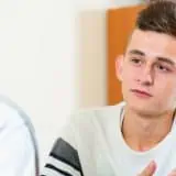 Teen boy talking to doctor