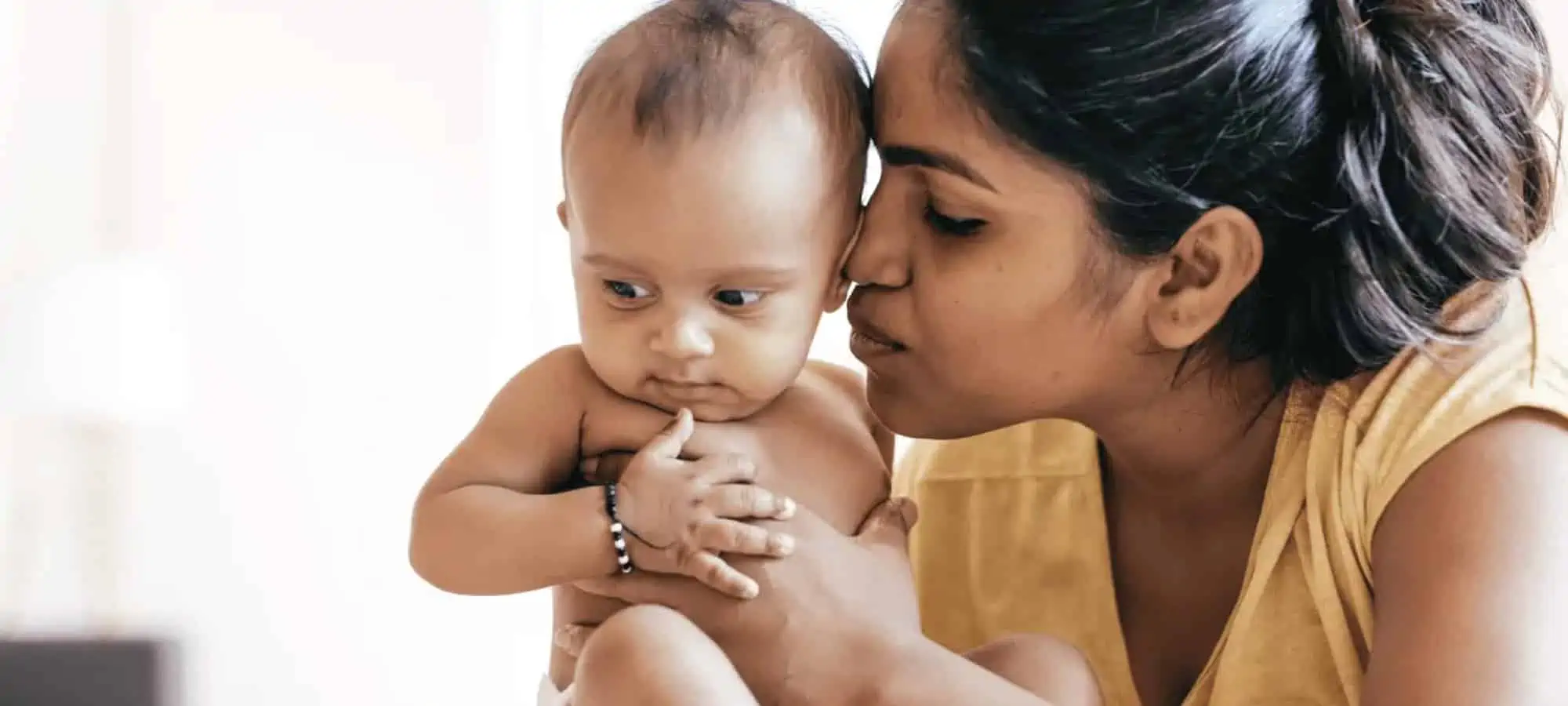 Mom kissing and holding baby