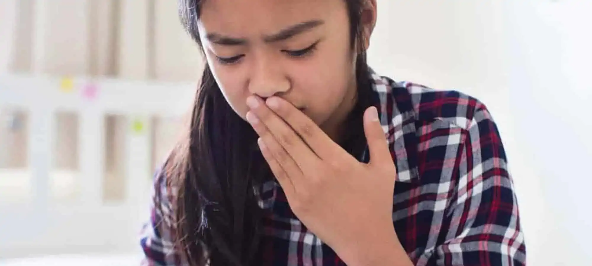 Girl holding mouth sick