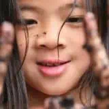 Girl with muddy hands