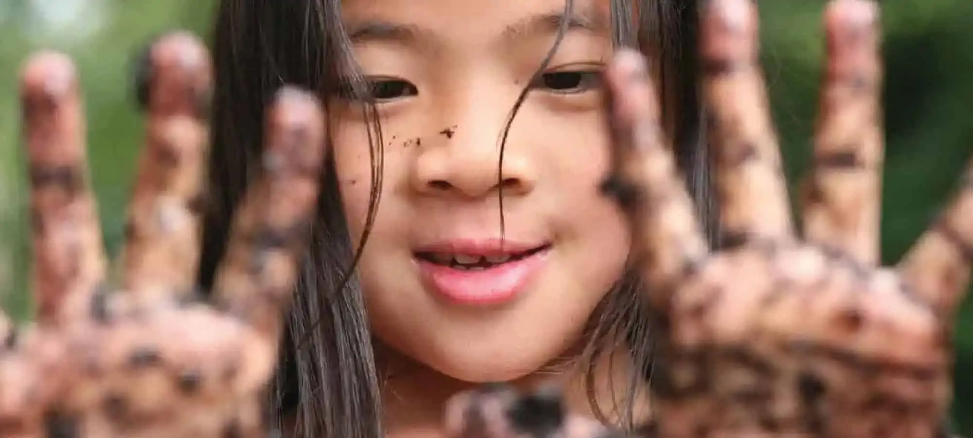 Girl with muddy hands
