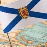Flag of New Brunswick on a pin stuck on a map showing New Brunswick