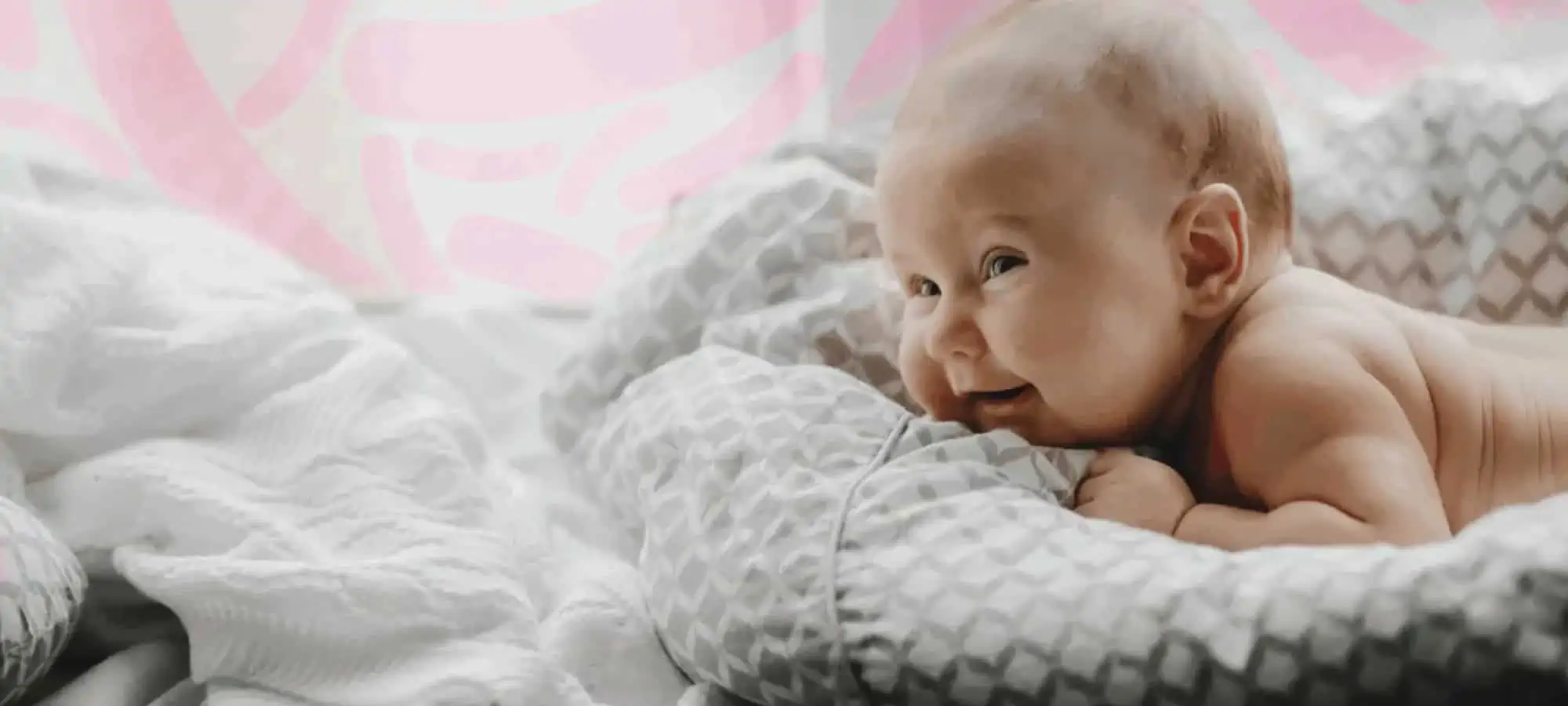 Baby laying down with microbes in the background