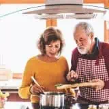 Senior and Women man cooking in kitchen