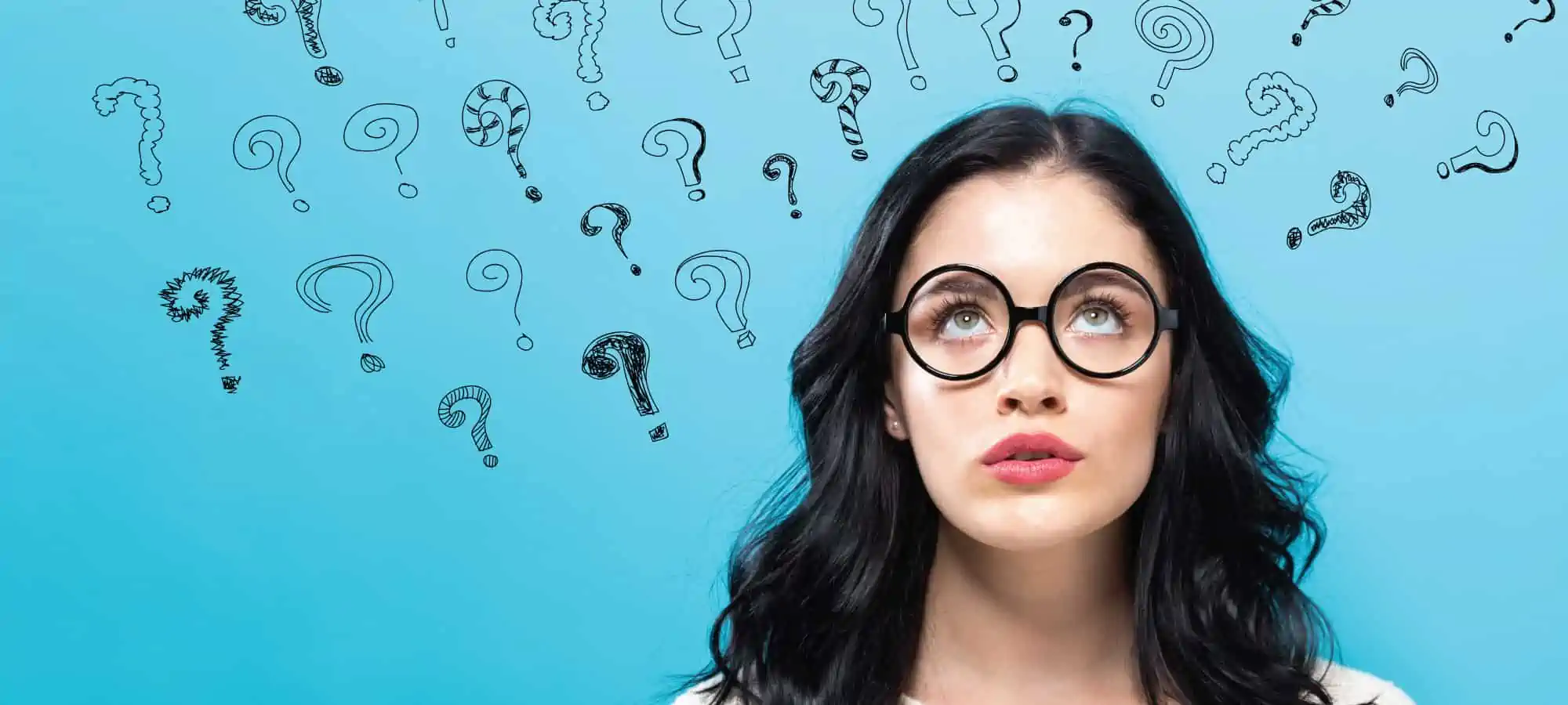 Women looking up with question marks above her head