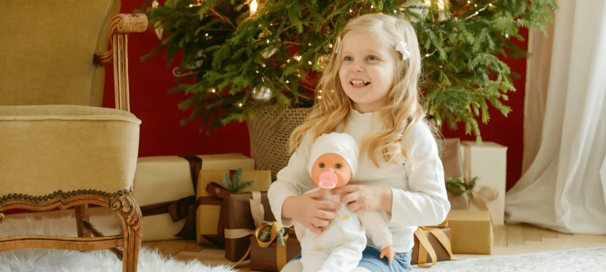 young girl holding baby doll