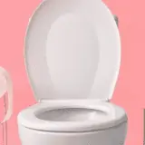 white toilet on pink background