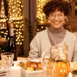 woman gathered with friends at dinner table