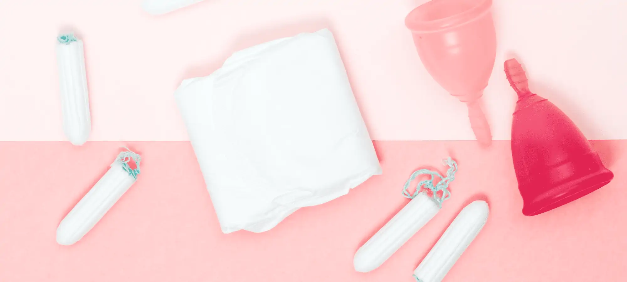 tampons, pads and menstrual cups on a pink background