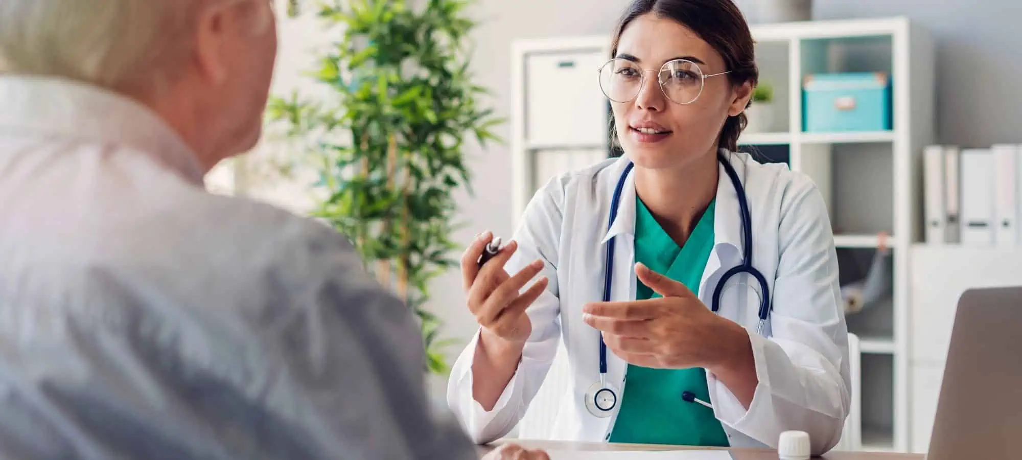 Young female doctor consulting an elderly patient in her office on a low-residue diet