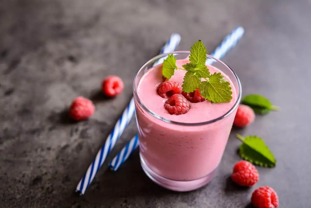 Glass of refreshing raspberry smoothie with fibre for elderly for breakfast