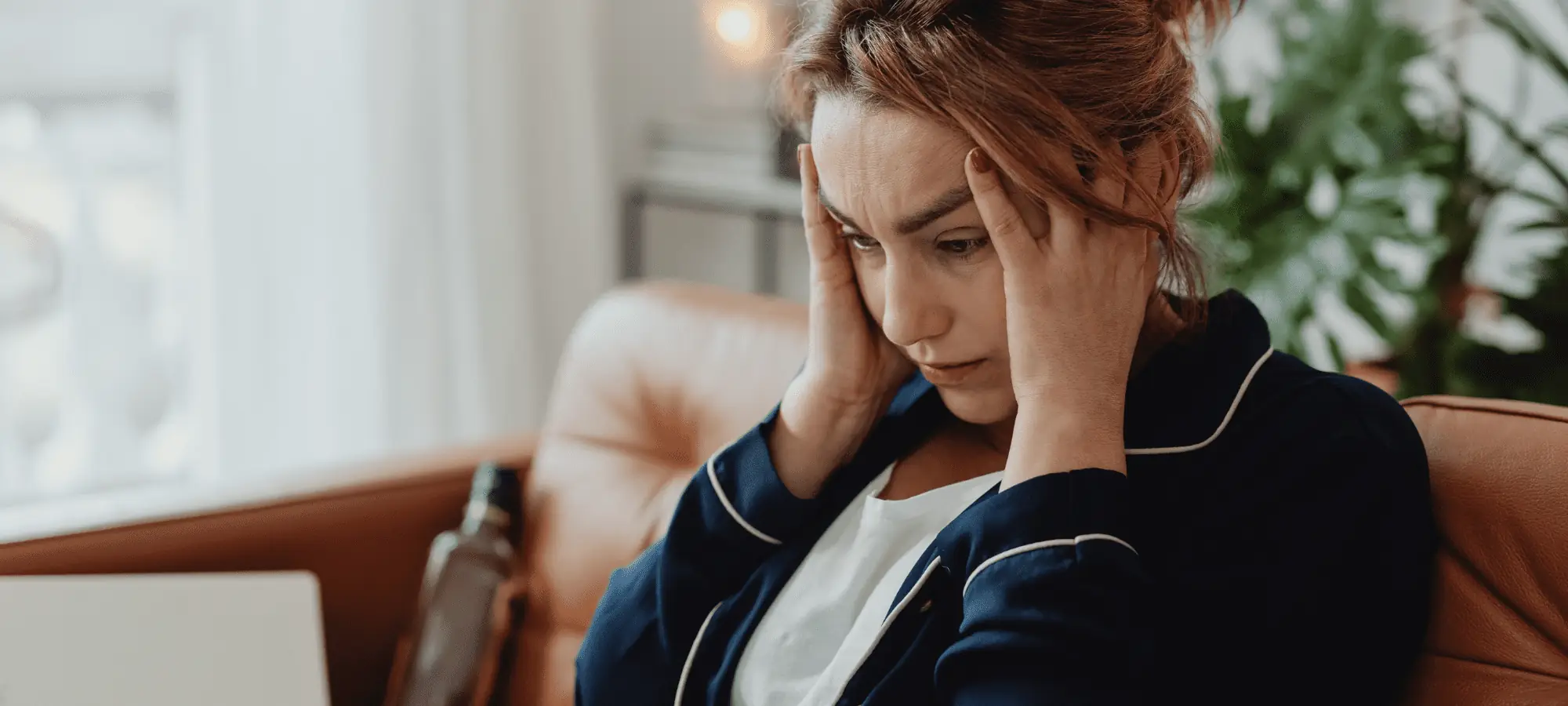 woman holding her temples due to stress