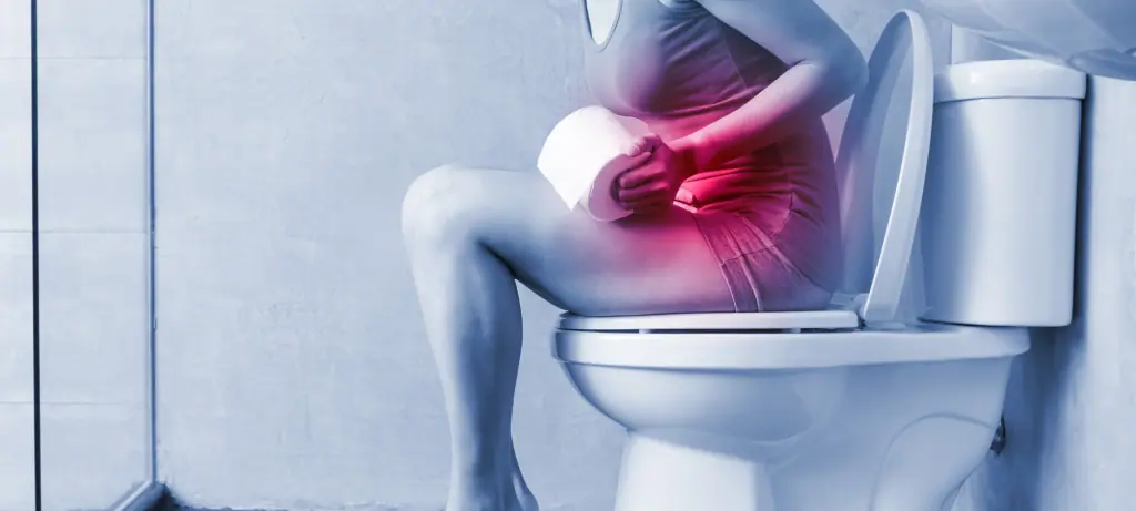 women sitting on the toilet with constipation 