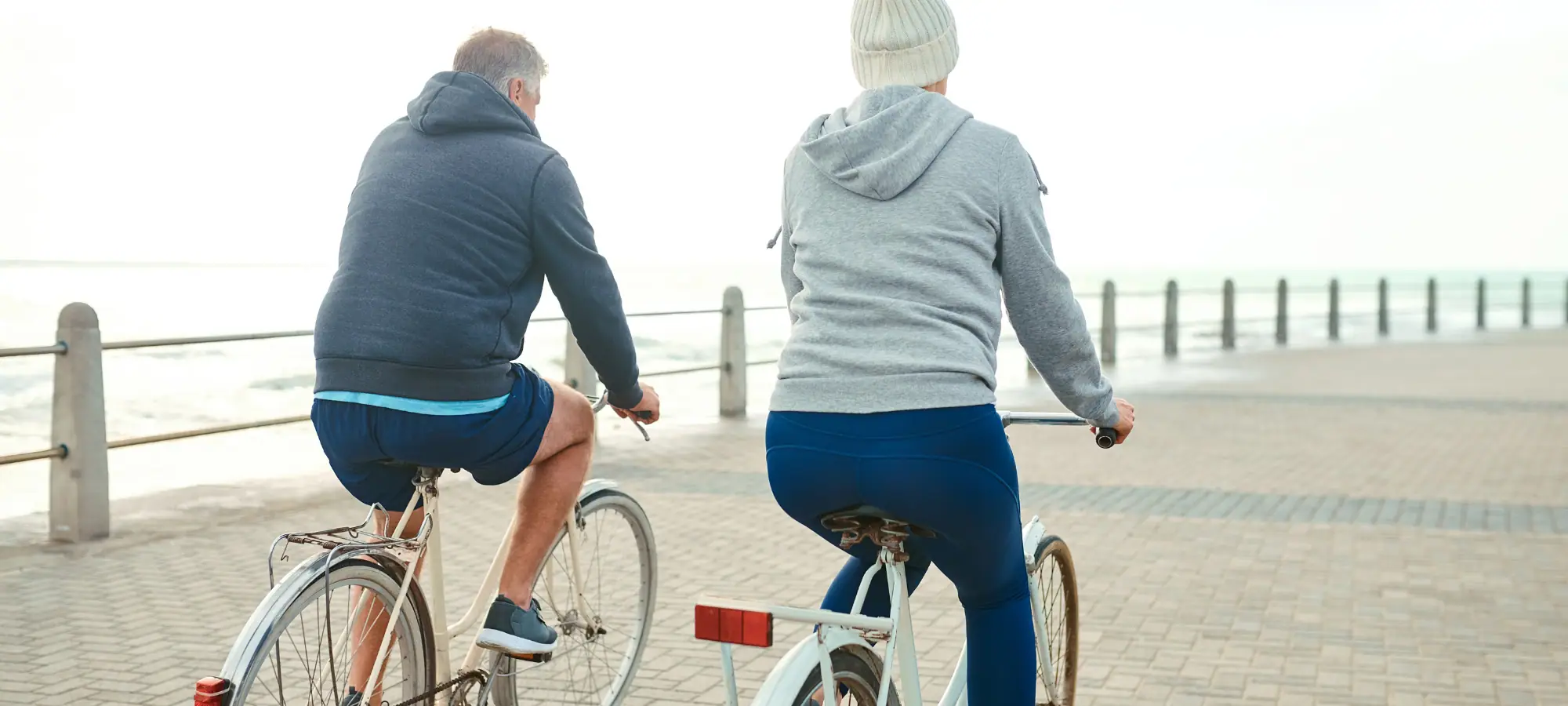 older couple riding on bikes getting exercise