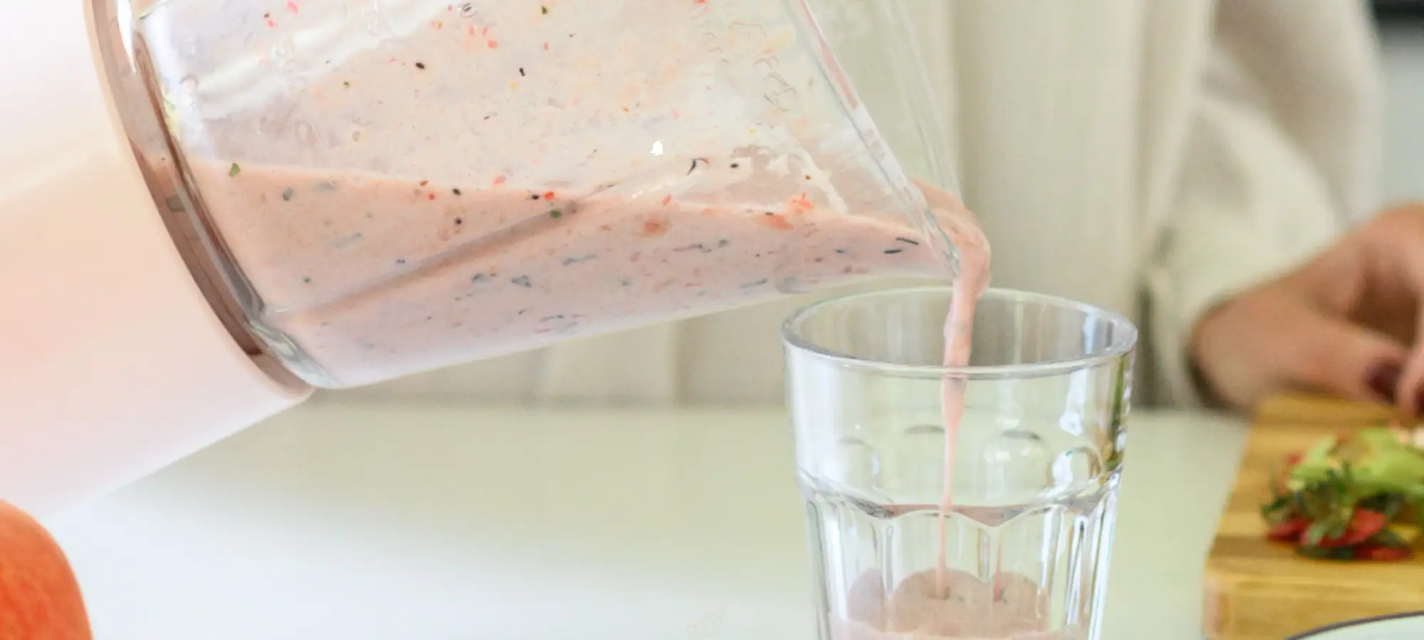 pouring lactose free smoothie into cup